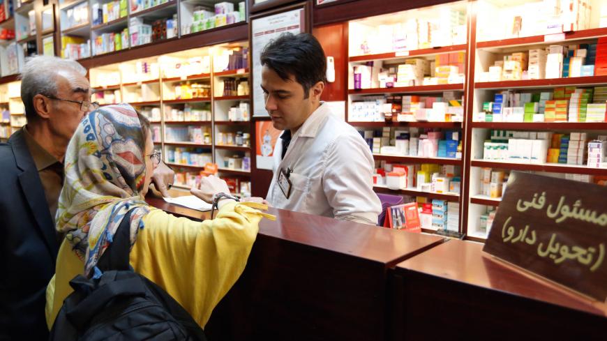 Iranians shop at a drugstore at the Nikan hospital in Tehran on September 11, 2018. - Judges at the International Court of Justice in The Hague unanimously ruled Washington should remove barriers to "the free exportation to Iran of medicines and medical devices, food and agricultural commodities" as well as airplane parts. Iran produces 96 percent of the drugs it uses, according to the Syndicate of Iranian Pharmaceutical Industries, but imports more than half the raw materials to make them. (Photo by STRING