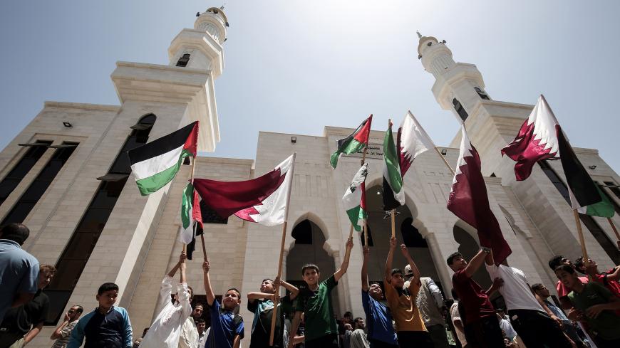 Palestinians attend a rally in support of Qatar, at the Qatari-funded housing project in the southern Gaza Strip city of Khan Yunis on June 9, 2017. / AFP PHOTO / SAID KHATIB        (Photo credit should read SAID KHATIB/AFP/Getty Images)