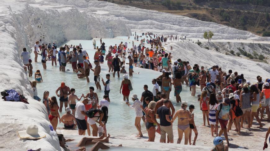 PAMUKKALE, TURKEY - AUGUST,27 (RUSSIA OUT) Tourists bath and walk white terrace of travertine, a carbonate mineral left by flowing flowing water in Pamukkale, Denizli Province, on August 27, 2017 in Turkey.  In 2014 Turkey had been rated the sixth most popular tourist destination in the World, welcoming 37 million visitors. In 2016 when Turkey was shaken by bombings, a failed military coup and a politcal crackdown, only 25 million came, according to the government. Photo by Mikhail Svetlov/Getty Images)