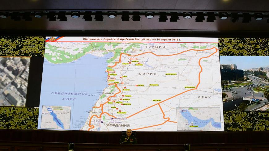 Russia's senior military officer Sergei Rudskoi sits bellow a map of Syria screened during a briefing at the Russian Defence Ministry headquarters in Moscow on April 14, 2018.
The Russian military said on April 14, 2018 that Western allies fired 103 cruise missiles including Tomahawk missiles at Syria but that Syrian air defence systems managed to intercept 71 of them. The US, Britain and France conducted joint strikes overnight on April 14 against the Syrian regime of Bashar al-Assad in response to alleged