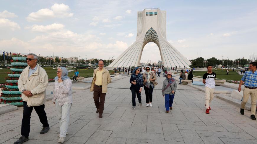 Tourists visit the Azadi Tower in the capital Tehran on April 19, 2018. - On April 15, the central bank banned foreign exchange bureaus "until further notice" from buying or selling foreign currency, leaving banks alone to carry out such transactions. But in practice, they refuse to do so, according to numerous testimonies. (Photo by ATTA KENARE / AFP)        (Photo credit should read ATTA KENARE/AFP/Getty Images)