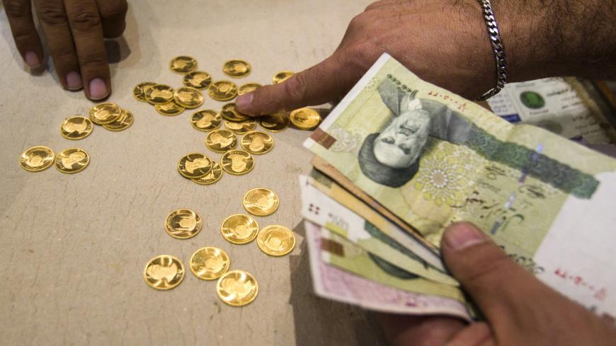 EDITORS' NOTE: Reuters and other foreign media are subject to Iranian restrictions on leaving the office to report, film or take pictures in Tehran.

A customer buys Iranian gold coins at a currency exchange office in Tehran's business district October 24, 2011. Iranian media reported last week that monetary authorities had reversed a six-month-old decision to cut interest on bank deposits, aiming to mop up excess cash in the economy and halt a dangerous rise of inflation. The news made sense to economist