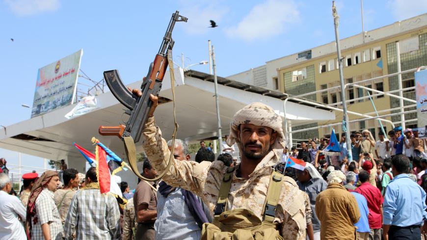 A southern Yemeni separatist fighter waves his rifle at the site of an anti-government protest in the port city of Aden, Yemen January 30, 2018. REUTERS/Fawaz Salman - RC1C77800070