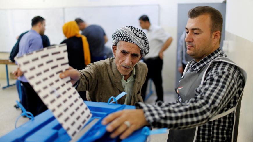 An elderly Kurdish man casts his vote at a polling station, during parliamentary elections in the semi-autonomous region in Erbil, Iraq September 30, 2018. REUTERS/Thaier Al-Sudani - RC193FA0F200