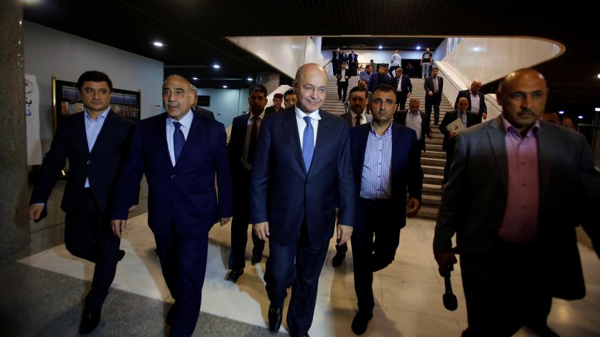 Barham Salih, Iraq's newly elected president, walks with Iraq's new Prime Minister Adel Abdul Mahdi at the parliament headquarters, in Baghdad, Iraq October 2, 2018. REUTERS/Khalid al Mousily - RC1CC4B29CE0