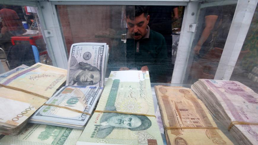 A man counts Iranian rials at a currency exchange shop, before the start of the U.S. sanctions on Tehran, in Basra, Iraq November 3, 2018. Picture taken November 3, 2018. REUTERS/Essam al-Sudani - RC11458A3740