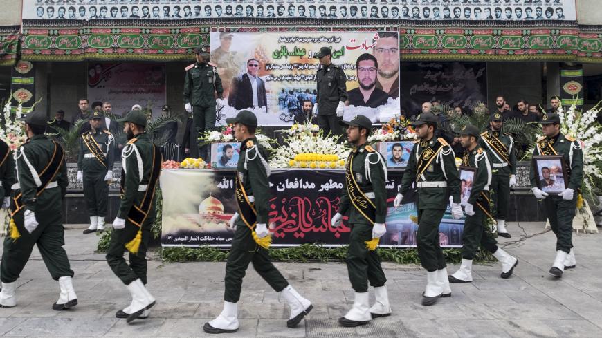 Iranian soldiers walk past coffins of two member of Iranian Revolutionary Guards who were killed in Syria, during their funeral in Tehran October 28, 2015. REUTERS/Raheb Homavandi/TIMA ATTENTION EDITORS - THIS IMAGE WAS PROVIDED BY A THIRD PARTY. FOR EDITORIAL USE ONLY. - GF20000036090