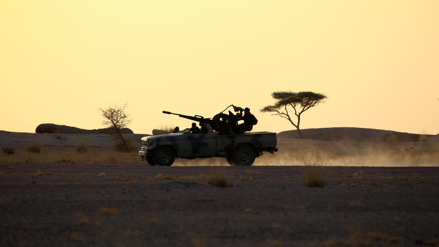 The Polisario Front soldiers drive a pick-up truck mounted with an anti-aircraft weapon during sunset in Bir Lahlou, Western Sahara, September 9, 2016. REUTERS/Zohra Bensemra          SEARCH “POLISARIO” FOR THIS STORY. SEARCH "WIDER IMAGE" FOR ALL STORIES.     - S1BEUKRIISAA