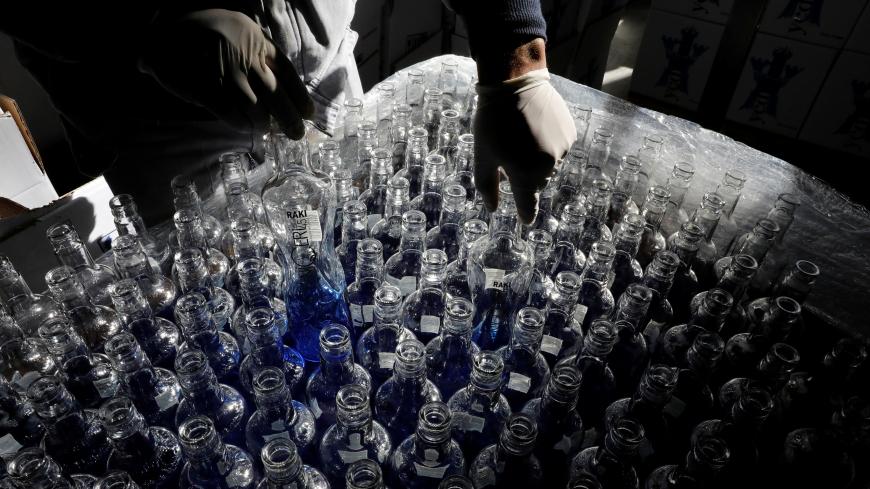 An employee checks bottles for Turkey's popular alcoholic drink raki at the Infotex Alkollu Icecekler plant in the town of Dinar, Turkey,  November 30, 2017. REUTERS/Umit Bektas - RC119E706970