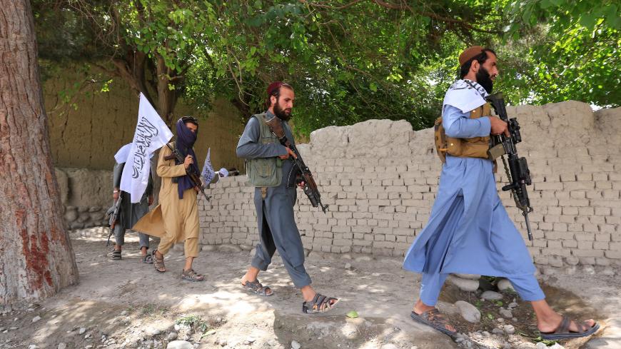 Taliban walk as they celebrate ceasefire in Ghanikhel district of Nangarhar province, Afghanistan June 16, 2018.REUTERS/Parwiz - RC1E925E3990