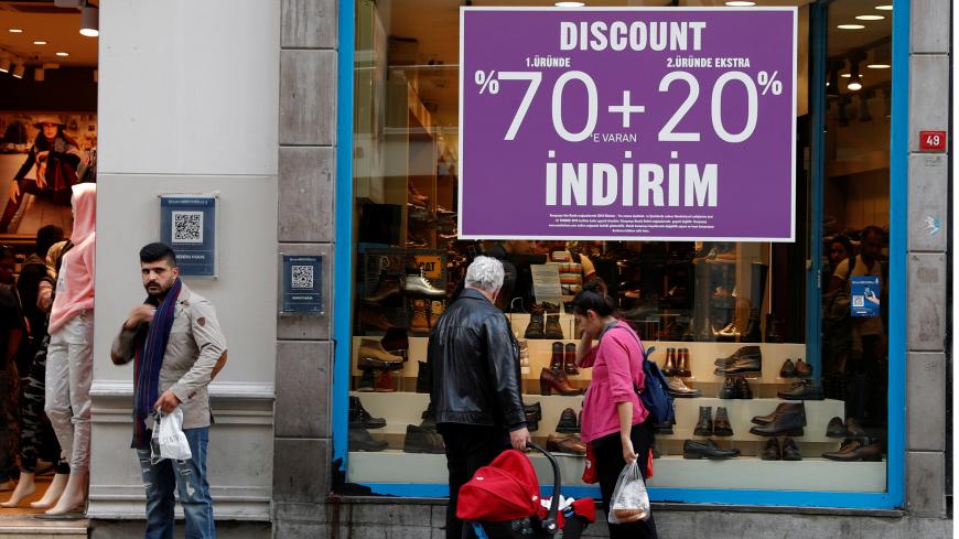 People look through a shop window in the main shopping and pedestrian street of Istiklal in central Istanbul, Turkey October 9, 2018. REUTERS/Murad Sezer - RC163B87C610