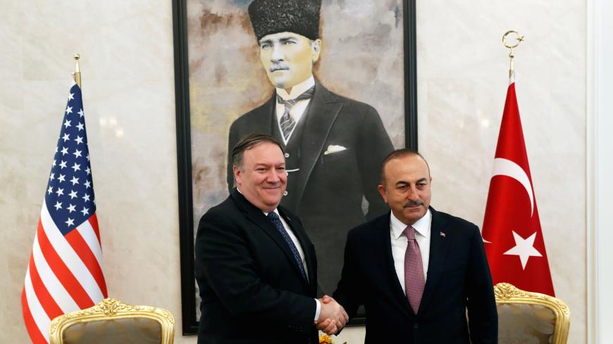 U.S. Secretary of State Mike Pompeo greets Turkish Foreign Minister Mevlut Cavusoglu before their meeting in Ankara, Turkey, October 17, 2018. REUTERS/Leah Millis/Pool - RC155B9647D0