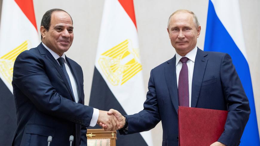 Russian President Vladimir Putin and Egyptian President Abdel Fattah al-Sisi shake hands during a signing ceremony following their meeting in the Black Sea resort of Sochi, Russia October 17, 2018. Pavel Golovkin/Pool via REUTERS - RC162A47A240
