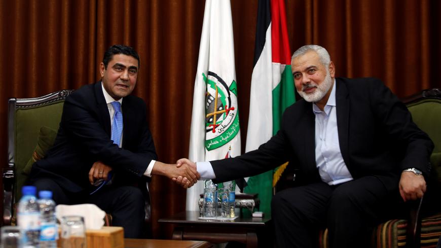 Hamas Chief Ismail Haniyeh shakes hands with Egyptian senior security official Ayman Badie during their meeting in Gaza City October 18, 2018. REUTERS/Mohammed Salem - RC1129B69360