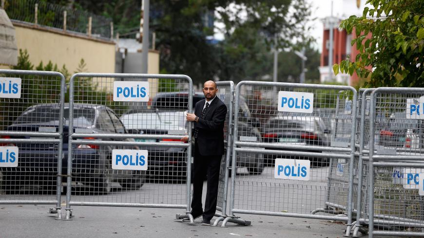 A member of security staff is seen next to the barriers at the gate of Saudi Arabia's consulate in Istanbul, Turkey, October 20, 2018. REUTERS/Osman Orsal - RC12AFAF48E0