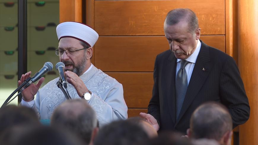 Turkish President Recep Tayyip Erdogan (R) and Imam Ali Erbas pray to officially open the newly built DITIB central mosque in Cologne, western Germany, on September 29, 2018. - The inauguration will be the closing event of the three-day state visit of Turkish President Recep Tayyip Erdogan, aimed at repairing frayed ties with Berlin after two years of tensions. (Photo by PATRIK STOLLARZ / AFP)        (Photo credit should read PATRIK STOLLARZ/AFP/Getty Images)