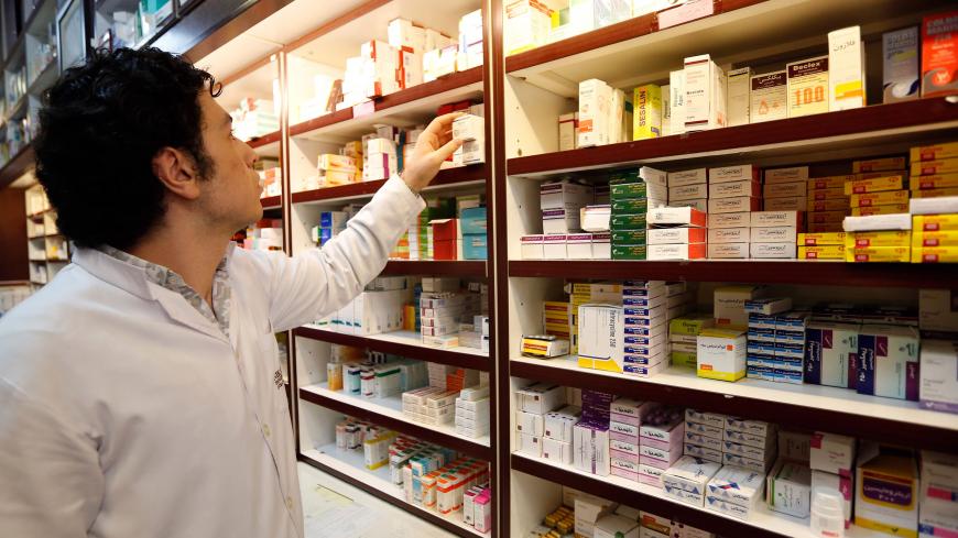 An Iranian man works at a drugstore at the Nikan hospital in Tehran on September 11, 2018. - Judges at the International Court of Justice in The Hague unanimously ruled Washington should remove barriers to "the free exportation to Iran of medicines and medical devices, food and agricultural commodities" as well as airplane parts. Iran produces 96 percent of the drugs it uses, according to the Syndicate of Iranian Pharmaceutical Industries, but imports more than half the raw materials to make them. (Photo by