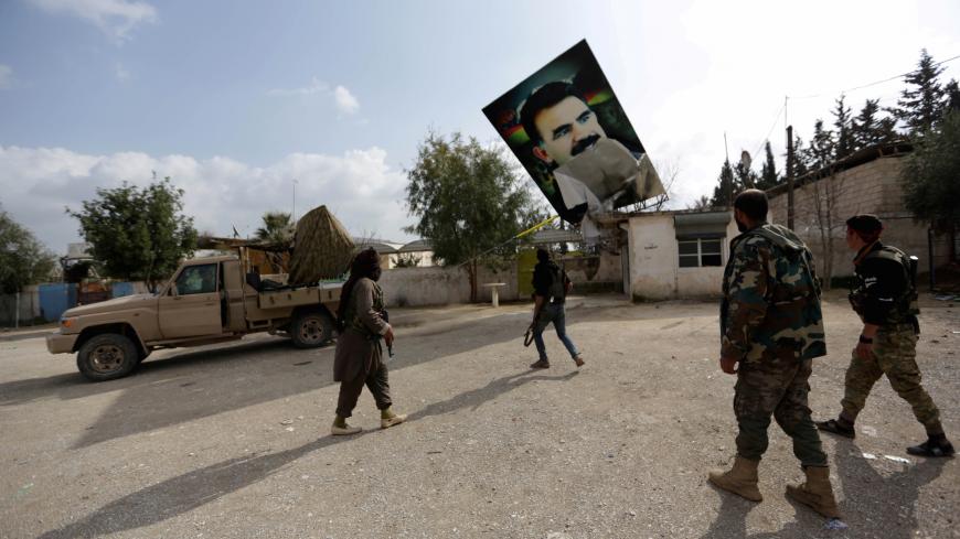 Turkish-backed Free Syrian Army fighters remove a picture of Kurdistan Workers Party (PKK) leader Abdullah Ocalan in Kafr Jana village north of Afrin, Syria March 7, 2018. REUTERS/Khalil Ashawi     TPX IMAGES OF THE DAY - RC1E52C8D060