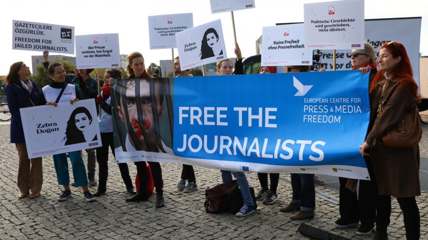 People hold placards prepared by Reporters Without Borders as they attend a demonstration organised for journalists detained in Turkey in front of the Berlin's main railway station, during the visit of Turkish President Tayyip Erdogan in Berlin, Germany, September 28, 2018.  REUTERS/Christian Mang - RC1CDC76C5D0