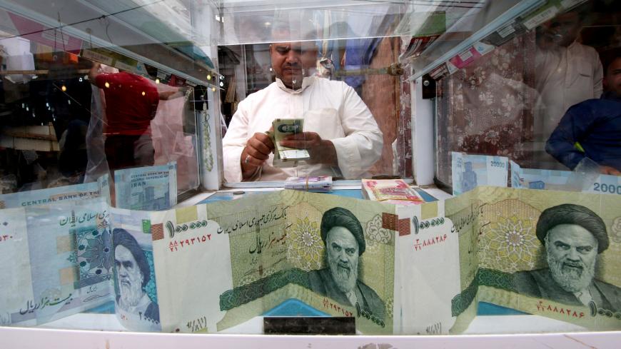 A man counts Iranian rials at a currency exchange shop, before the start of the U.S. sanctions on Tehran, in Basra, Iraq November 3, 2018. Picture taken November 3, 2018. REUTERS/Essam al-Sudani - RC153985B7A0