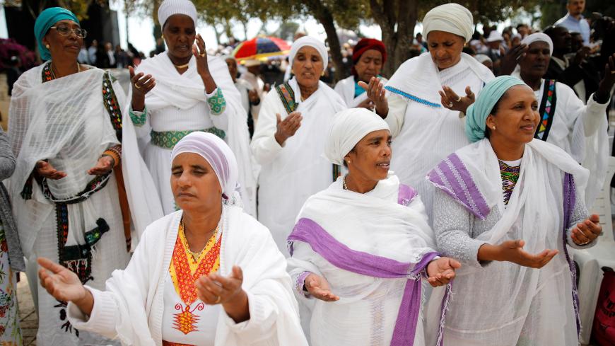 Members of the Israeli Ethiopian community pray during a ceremony marking the Ethiopian Jewish holiday of Sigd in Jerusalem November 7, 2018. REUTERS/Amir Cohen - RC1C4FC2C450