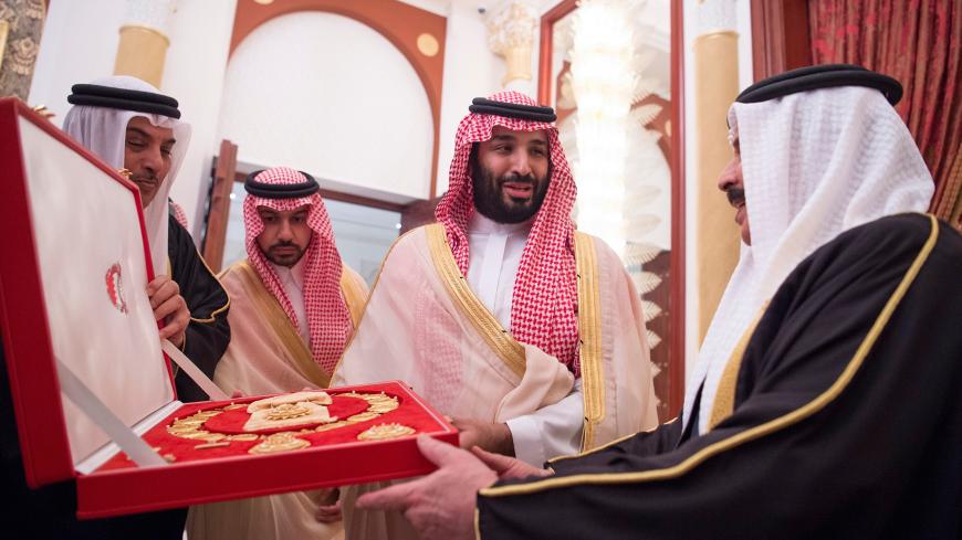 Saudi Arabia's Crown Prince Mohammed bin Salman Al Saud receives a gift from Bahraini King Hamad bin Isa Al Khalifa in Manama, Bahrain, November 26, 2018.  Bandar Algaloud/Courtesy of Saudi Royal Court/Handout via REUTERS   ATTENTION EDITORS - THIS PICTURE WAS PROVIDED BY A THIRD PARTY? - RC12300BE420