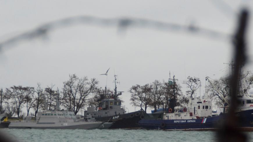 Three Ukrainian naval ships (L), which were recently seized by Russia's FSB security service, are seen anchored in a port in Kerch, Crimea November 28, 2018. REUTERS/Alla Dmitrieva - RC18F447FA20