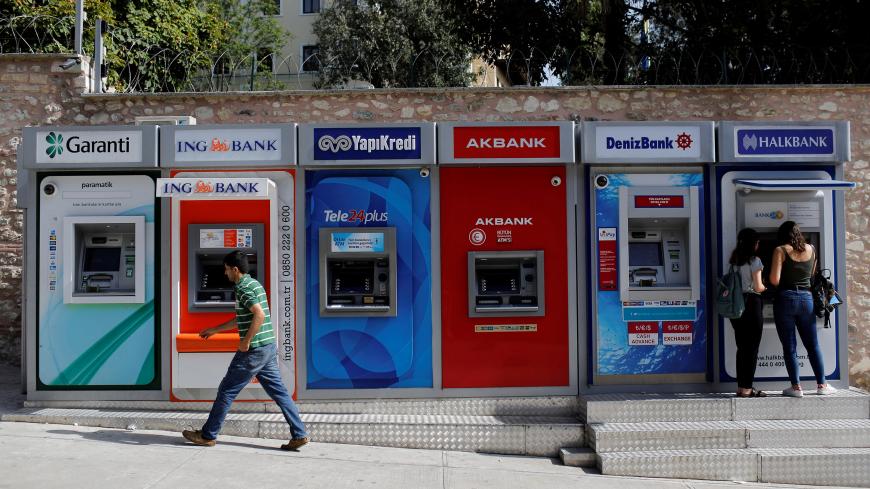 Women withdraw cash from an ATM of Halkbank in Istanbul, Turkey, September 12, 2017. REUTERS/Murad Sezer - RC1806970730