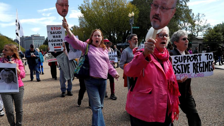 Activists, including Aimee Artigliere, center, chant as they begin to march during a demonstration calling for sanctions against Saudi Arabia and against the disappearance of Saudi journalist Jamal Khashoggi, outside the White House in Washington, U.S., October 19, 2018. REUTERS/Leah Millis - RC195EEDBBA0