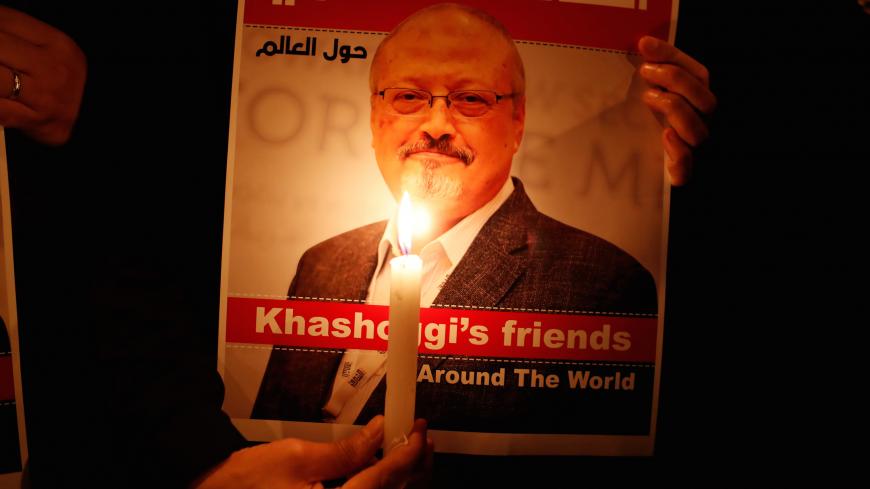 A demonstrator holds a poster with a picture of Saudi journalist Jamal Khashoggi outside the Saudi Arabia consulate in Istanbul, Turkey October 25, 2018. REUTERS/Osman Orsal - RC18135CA760