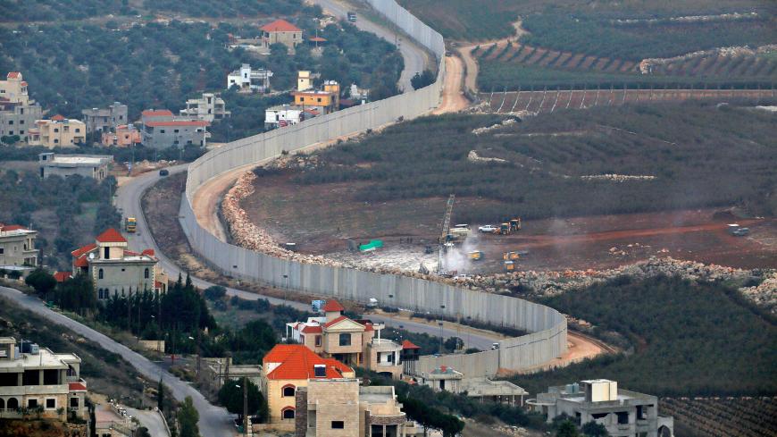 This picture taken on December 4, 2018 near the northern Israeli town of Misgav Am, shows Israeli machinery operating machinery (R) near the border wall with Lebanon. - Israel's army said on December 4 it had detected Hezbollah "attack tunnels" infiltrating its territory from Lebanon and had launched an operation called "Northern Shield" to destroy them, a move likely to raise tensions with the Iran-backed group. (Photo by JALAA MAREY / AFP)        (Photo credit should read JALAA MAREY/AFP/Getty Images)