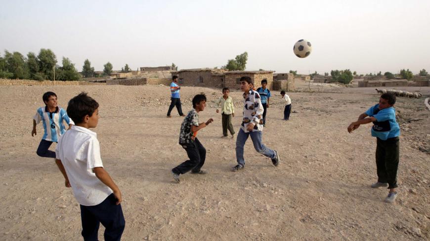 Arbil, IRAQ:  Kurdish refugee children play soccer at the Mahkmour Refugees Camp of Arbil 09 August 2005. Nearly 10 thousands refugees live at the temporary Makhmour Camp where migrating Kurds from Turkey settled from 1990 till 1995. This camp is under the control of BM and PKK (Kurdistan Workers Party). AFP PHOTO/MUSTAFA OZER  (Photo credit should read MUSTAFA OZER/AFP/Getty Images)