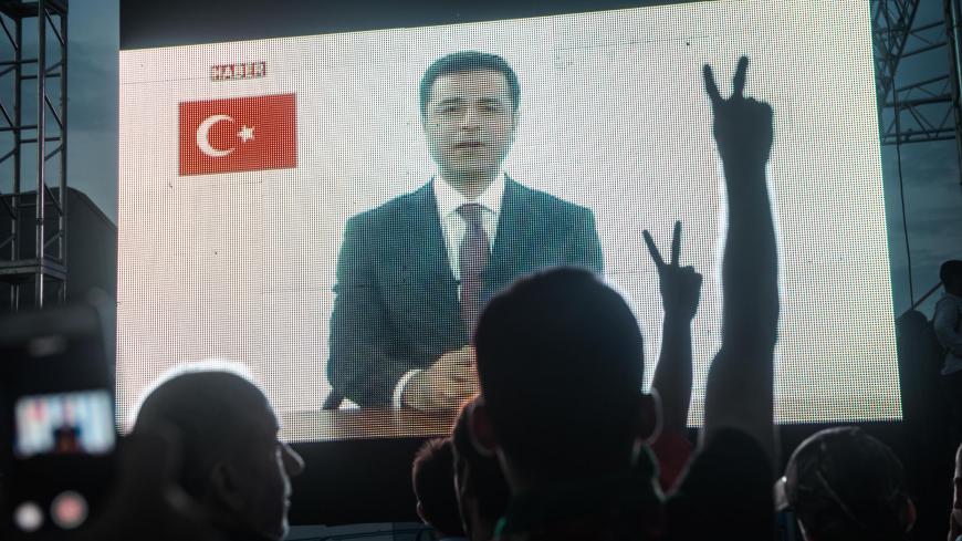 Supporters watch large screens as they listen to the Selahattin Demirtas, presidential candidate of the pro-Kurdish People's Democratic Party (HDP) speak during an election campaign in Istanbul on June 17, 2018. - The Turkish president announced on April 18, 2018 that Turkey will hold snap parliamentary and presidential elections on June 24, 2018. The presidential and parliamentary elections were scheduled to be held in November 2019, but government has decided to change the date following the recommendatio