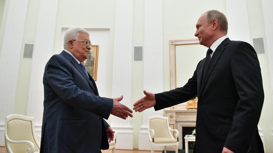 Russian President Vladimir Putin (R) shakes hands with Palestinian President Mahmud Abbas during their meeting at the Kremlin in Moscow on July 14, 2018. (Photo by Yuri KADOBNOV / AFP)        (Photo credit should read YURI KADOBNOV/AFP/Getty Images)