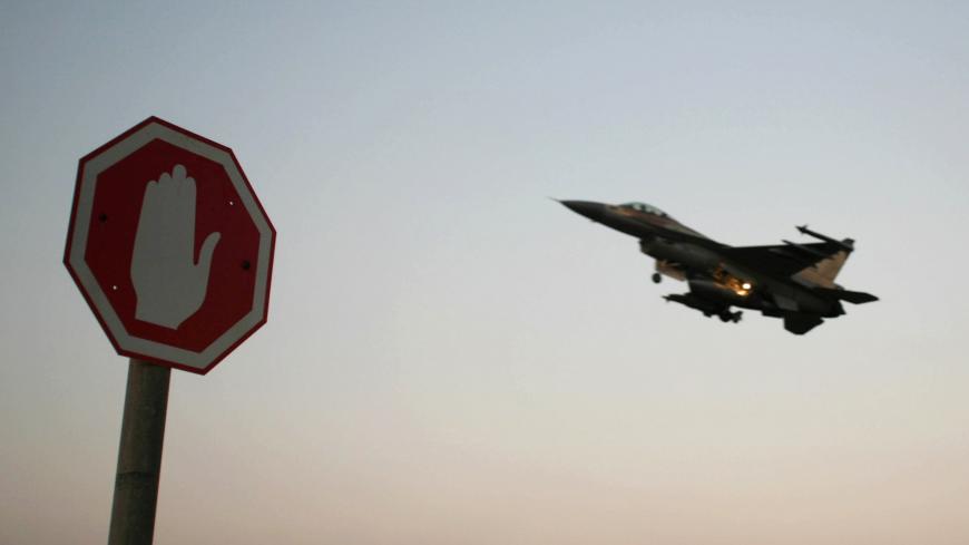 An Israeli Air Force F-16 fighter plane flying above a traffic sign after taking off for a mission in Lebanon from an Israeli Air Force Base in northern Israel in this July 20, 2006 file photo. Israeli warplanes bombed unidentified Syrian targets early on September 6, 2007, causing no damage or casualties, the official Syrian news agency said. Syrian air defences fired at the incoming planes, which crossed into Syria after midnight local time, the agency said. REUTERS/Ammar Awad/Files (ISRAEL) - GM1DWCBQYXA