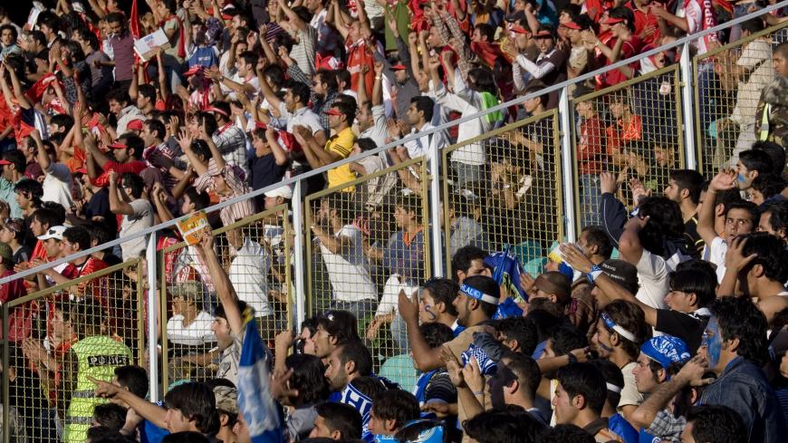 Esteghlal and Persepolis fans sit separately during their Iran Serie A soccer match at the Azadi (freedom) stadium in Tehran October 14, 2007.  REUTERS/Morteza Nikoubazl (IRAN) - GM1DWJHVHFAA
