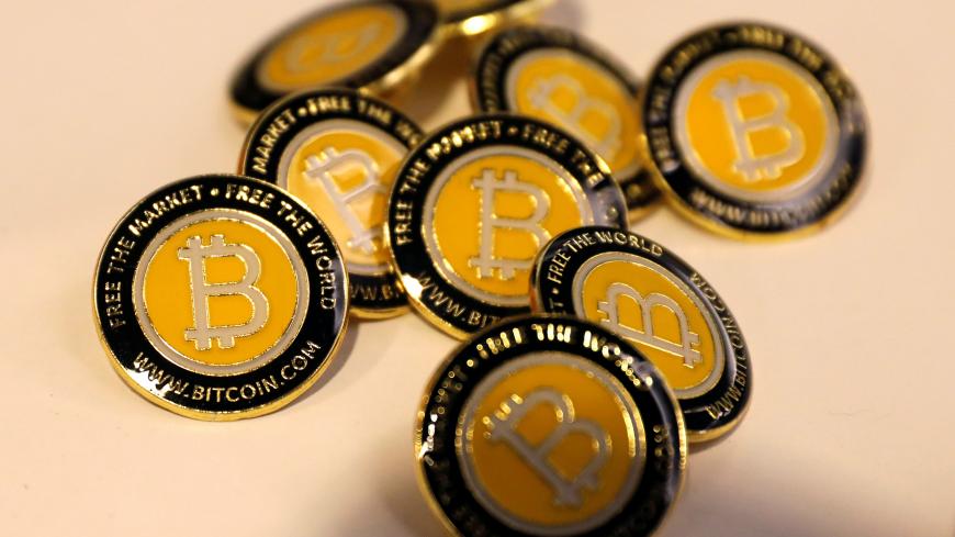 Bitcoin.com buttons are seen displayed on the floor of the Consensus 2018 blockchain technology conference in New York City, New York, U.S., May 16, 2018. REUTERS/Mike Segar - RC1B17B79620