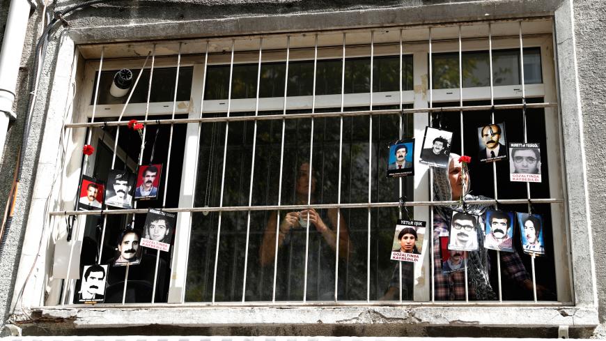 A member of the Saturday Mothers looks out of the window of Human Rights Association after they were prevented by the security forces to march to Galatasaray Square, where they hold a vigil every week, sitting in silence and holding pictures of relatives who went missing in police detention, in Istanbul, Turkey September 8, 2018. REUTERS/Murad Sezer - RC1FDA40D300