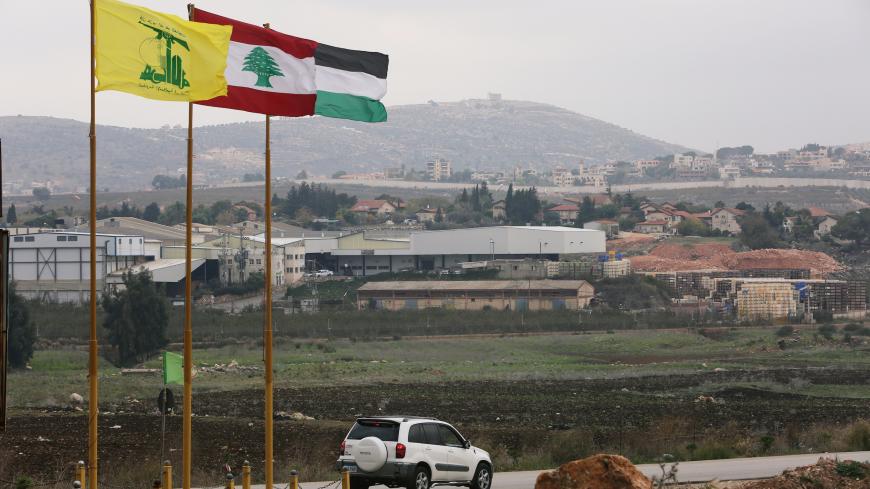 Flags of Hezbollah, Lebanon and Palestine are seen fluttering near the border with Israel in the village of Khiam, Lebanon December 4, 2018. REUTERS/Ali Hashisho - RC1797CA76B0