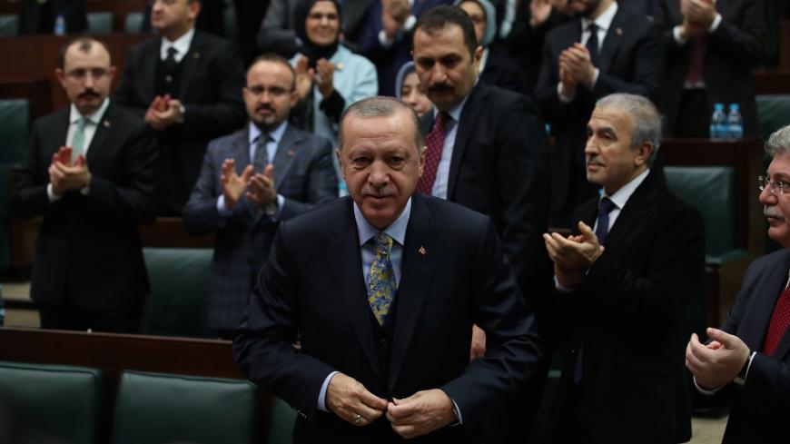 Turkish President Tayyip Erdogan leaves his seat to address members of parliament from his ruling AK Party (AKP) during a meeting at the Turkish parliament in Ankara, Turkey, January 15, 2019. REUTERS/Umit Bektas - RC177363CD90