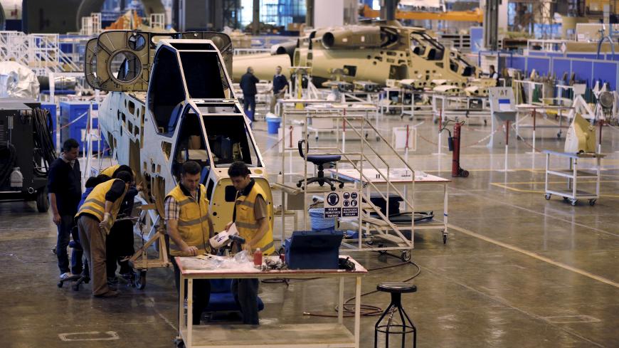 Technicians construct a Turkish Attack and Tactical Reconnaissance Helicopter (ATAK) at the Turkish Aerospace Industries Inc (TAI) factory in Ankara, Turkey, April 28, 2015. TAI, which produces F-16 fighter jets and other military aircraft, could float on the Istanbul stock exchange in the second half of this year, its chief executive told Reuters. Ankara-based TAI was established to co-produce Lockheed Martin's F-16 for the Turkish Air Force in 1984. It is almost wholly owned by the Turkish Armed Forces Fo