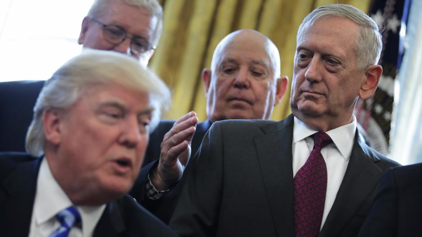 U.S. Defense Secretary James Mattis looks at U.S. President Donald Trump as he speaks during a meeting with Medal of Honor recipients in the Oval Office of the White House in Washington, U.S., March 24, 2017. REUTERS/Carlos Barria - RC143321C440