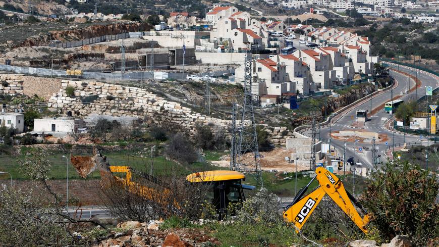 An Israeli machinery removes trees near a Jewish settlement in Hebron, in the occupied West Bank February 21, 2018. REUTERS/Mussa Qawasma - RC14AB0BB000