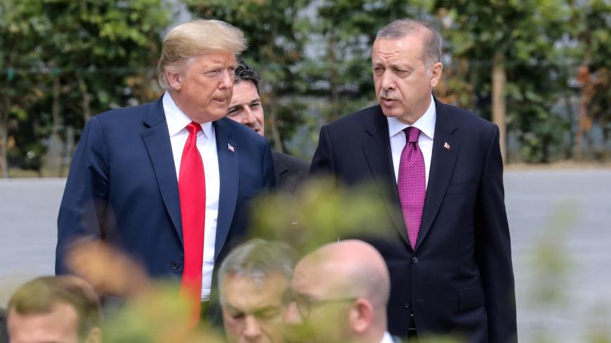 U.S. President Donald Trump speaks withh Turkey's President Tayyip Erdogan ahead of the opening ceremony of the NATO (North Atlantic Treaty Organization) summit, at the NATO headquarters in Brussels, Belgium, July 11, 2018.  Ludovic Marin/Pool via REUTERS - RC19136AAEC0