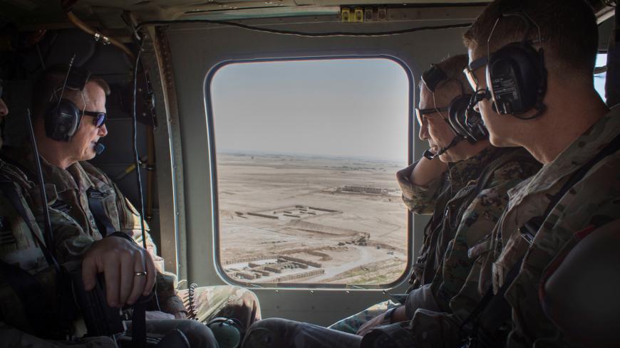 General Chiya, commander of the Syrian Democratic Forces in Syria’s Middle Euphrates River Valley, speaks with U.S. Army Lieutenant General Paul E. Funk, commander of Combined Joint Task Force-Operation Inherent Resolve and Major General James B. Jarrard, commander of Special Operations Joint Task Force-Operation Inherent Resolve, as they fly in a helicopter over Syria July 11, 2018. Picture taken July 11, 2018.  U.S. Army/Sgt. Brigitte Morgan/Handout via REUTERS  ATTENTION EDITORS - THIS IMAGES WAS PROVIDE