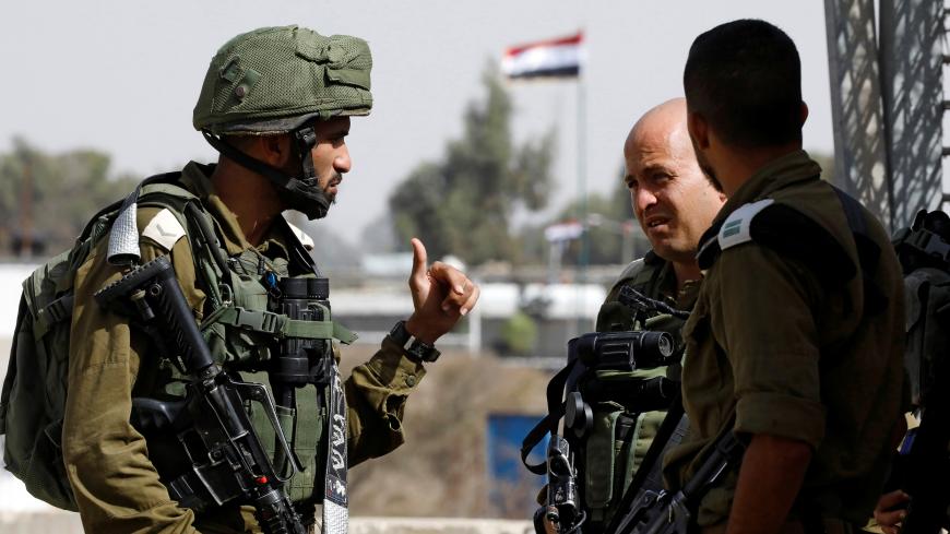 Israeli soldiers chat as they stand near the Quneitra crossing in the Golan Heights on the border line between Israel and Syria, October 15, 2018. REUTERS/Amir Cohen - RC1DE3AFB000