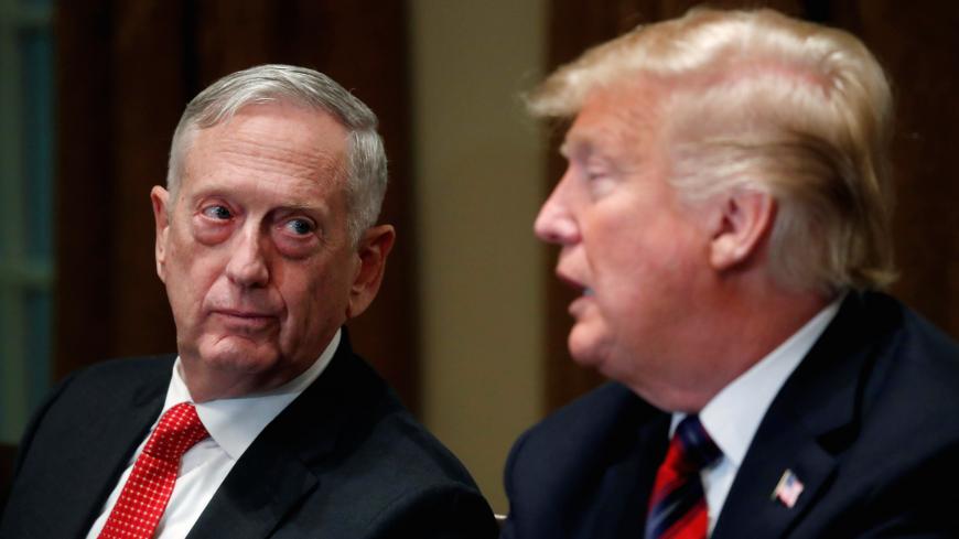 U.S. Defense Secretary James Mattis listens as U.S. President Donald Trump speaks to the news media while gathering for a briefing from his senior military leaders in the Cabinet Room at the White House in Washington, U.S., October 23, 2018. REUTERS/Leah Millis - RC1C2E1A2820
