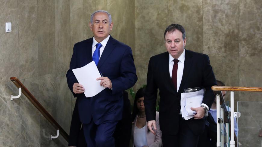 Israeli Prime Minister Benjamin Netanyahu (L) and Prime Minister's Office Director Yoav Horowitz arrive to the weekly cabinet meeting at his office in Jerusalem December 16, 2018. Abir Sultan/Pool via REUTERS - RC115D97C030