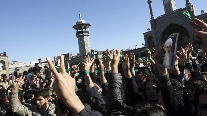EDITORS' NOTE: Reuters and other foreign media are subject to Iranian restrictions on their ability to film or take pictures in Tehran. 

Supporters of the Iranian opposition movement wear green during the funeral of Grand Ayatollah Hossein Ali Montazeri in the holy city of Qom December 21, 2009. Big crowds of mourners chanted anti-government slogans during the funeral of Iran's leading dissident cleric, Grand Ayatollah Hossein Ali Montazeri, in the holy city of Qom on Monday, websites reported. REUTERS/v