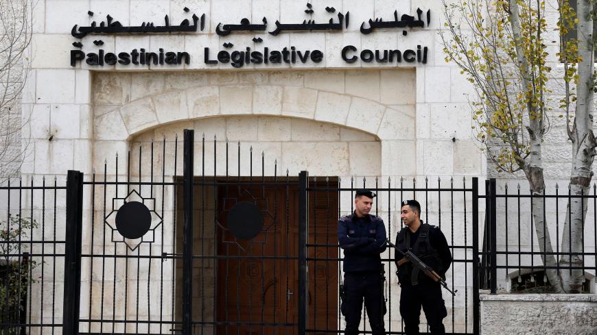 Palestinian security forces gather in front of the Palestinian Legislative Council building in Ramallah in the Israeli-occupied West Bank on December 26, 2018. - Palestinian president Mahmud Abbas said on December 22, that he intended to dissolve the largely defunct Palestinian parliament controlled by his rivals Hamas following a court decision ordering the move. Abbas did not say when the Ramallah-based Palestinian Constitutional Court issued the ruling that includes holding elections within six months of